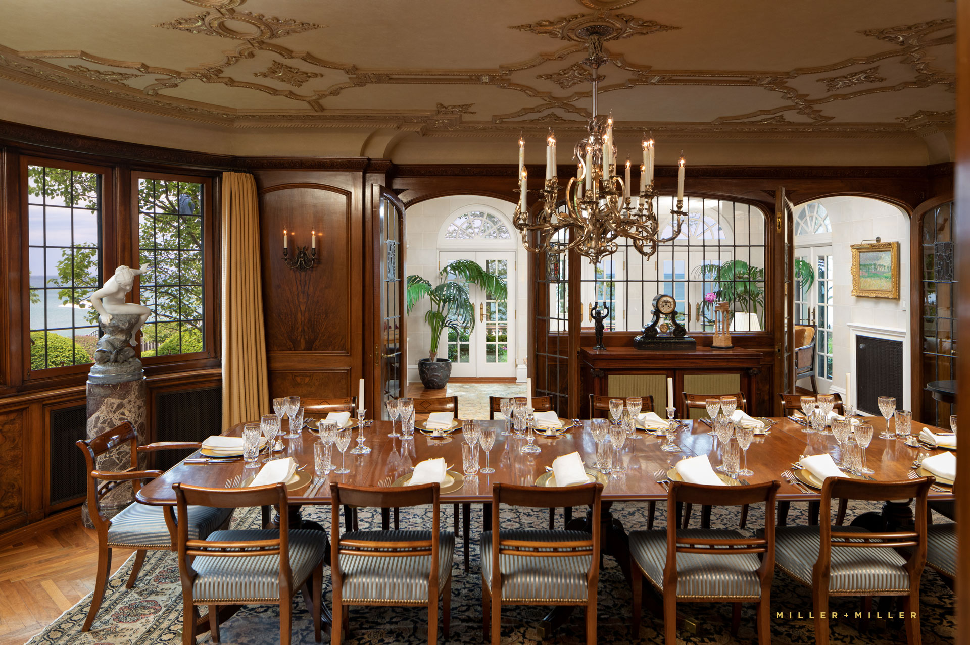 formal mahogany handcarved walls gold ornate plaster ceiling molding dining room chandelier conservatory lake overlook